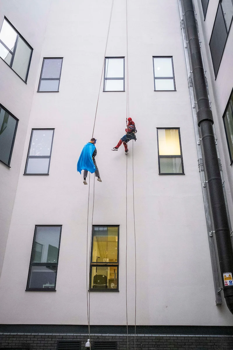 tree surgeons abseiling down edinburgh hospital.